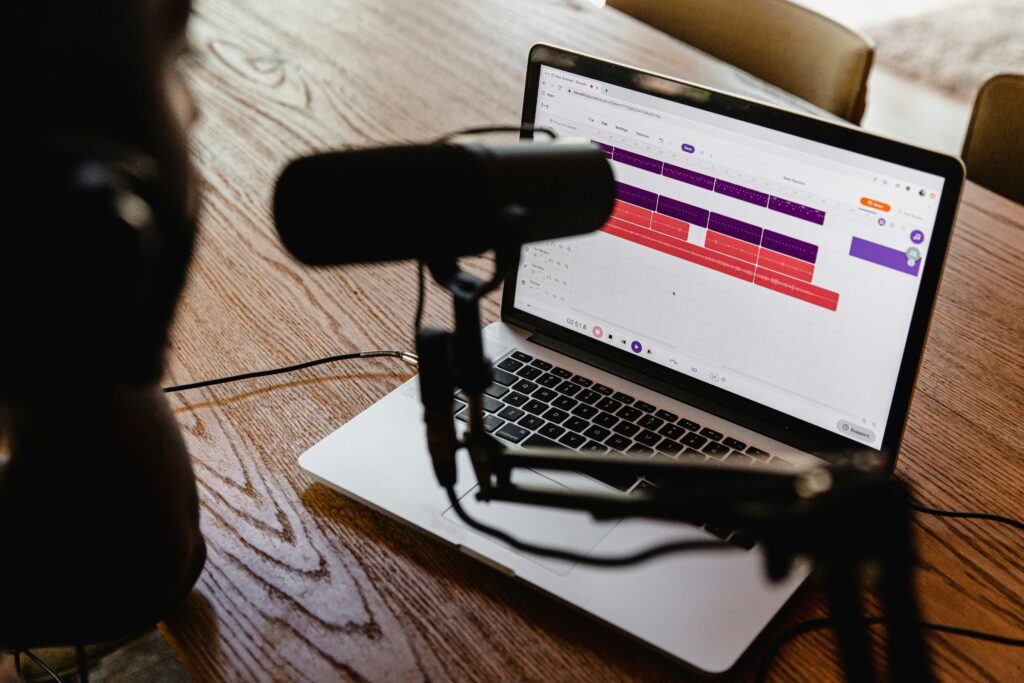 With a microphone in front of laptop, this photo is meant to illustrate what it might be like to do a podcast