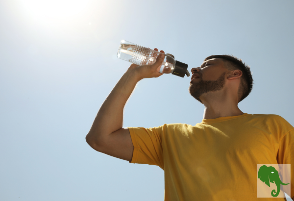 Man in Sun drinking water