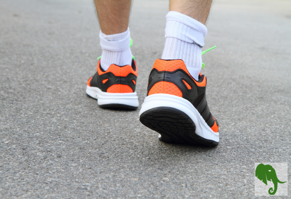 Walking with close-up for feet / shoes from behind