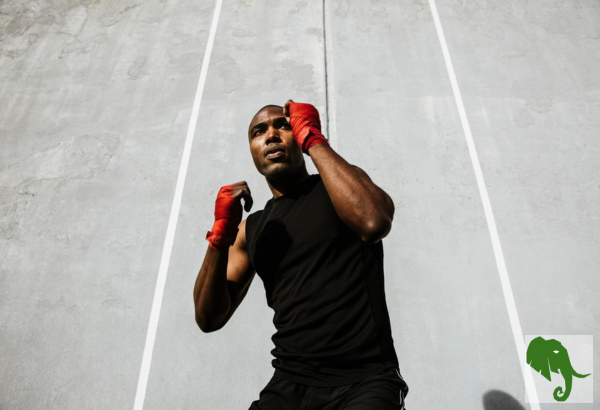 Man with wrapped hands held up as if to be boxing