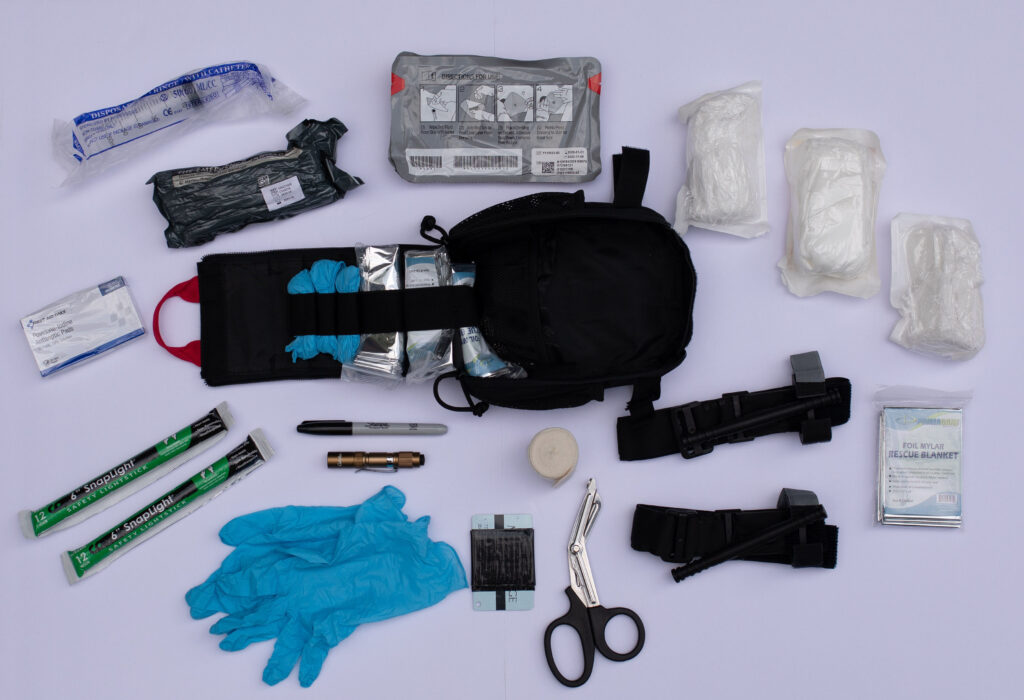 basic trauma kit open with contents spread out for viewing