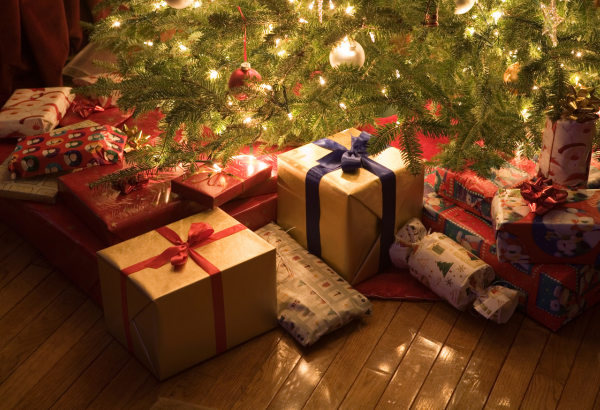 edge of Christmas tree with soft lighting and gifts